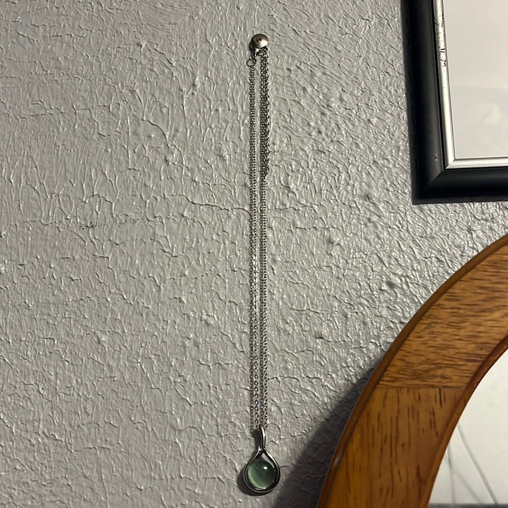 Small necklace with a green pendant.